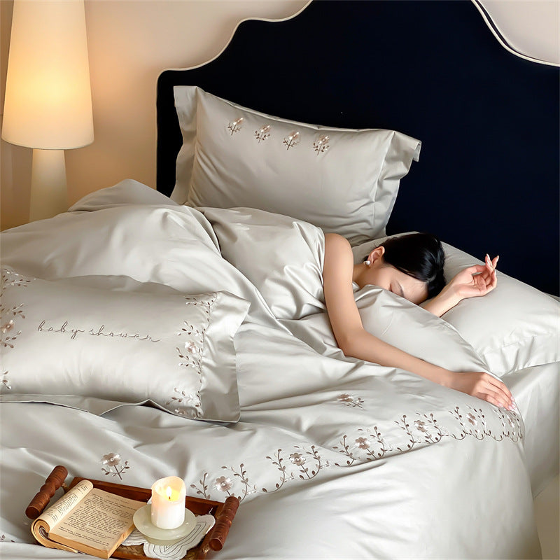 Satin bedding set with delicate flower embroidery and silk-soft touch
