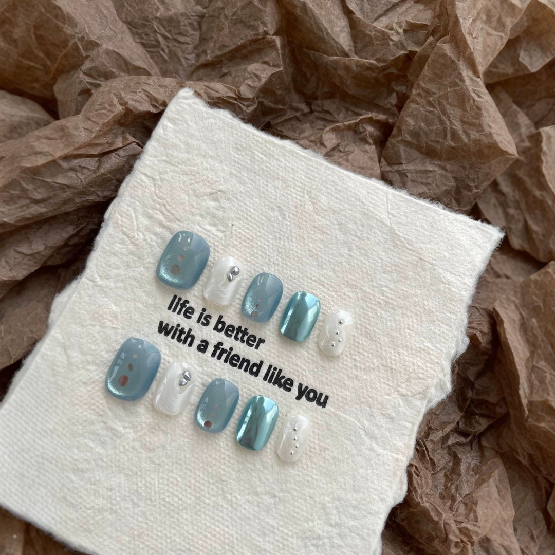 Artistic Press-On Nail Art Set with Unique Button and Ocean-Inspired Designs