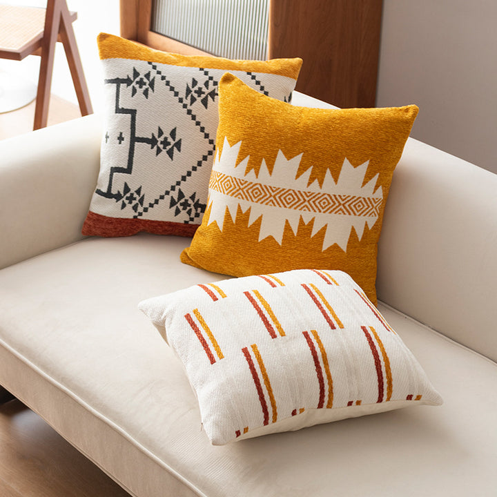 Woven cushion cover with graphic ethnic pattern and contrasting borders