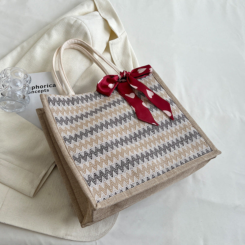 Textured Handbag with Decorative Bow