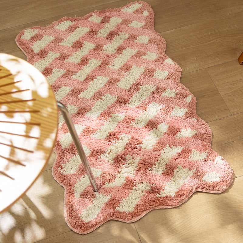 Tufted bathroom mat with wavy edge and geometric relief