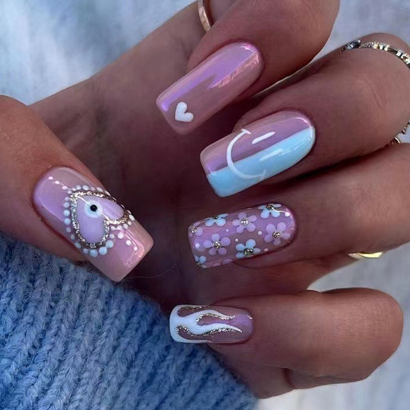 Artful nail art with floral accents and glitter embellishments Kalsten