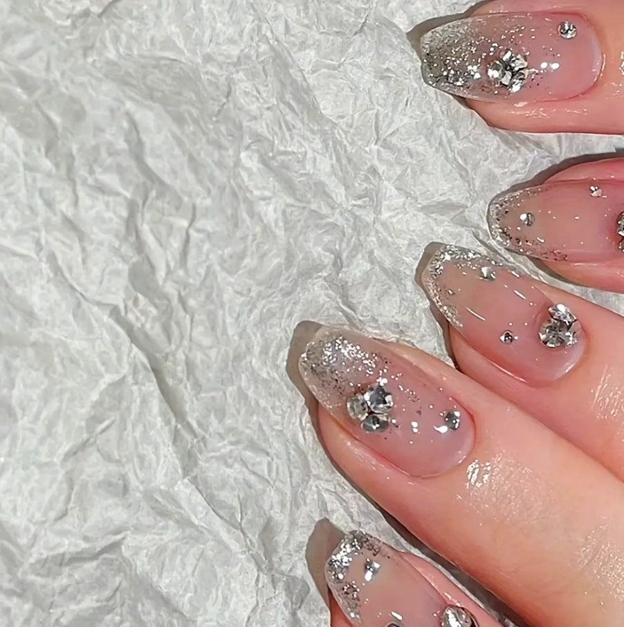 Glamorous artificial nails with glitter and rhinestone embellishments Kalsten