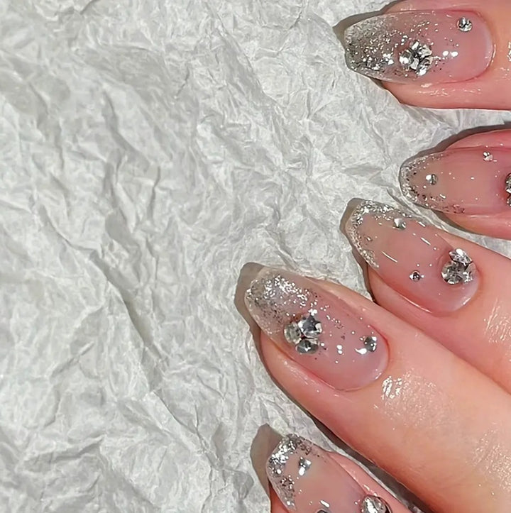 Glamorous artificial nails with glitter and rhinestone embellishments Kalsten