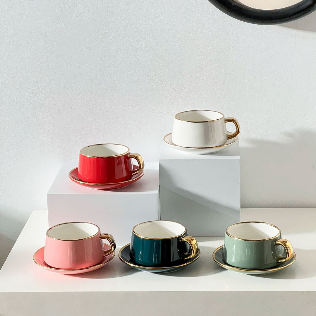Elegant porcelain cup with saucer and sculptural gold handle