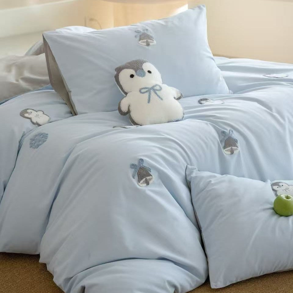 Children's bedding set with embroidered penguin appliqués and plush cuddle details