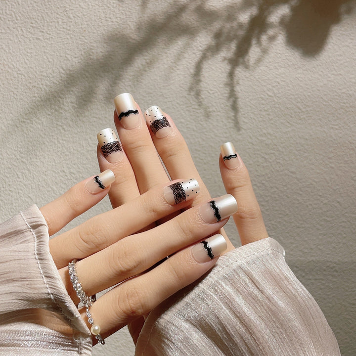 Artistic Press-On Nail Design with Lace and Polka Dots