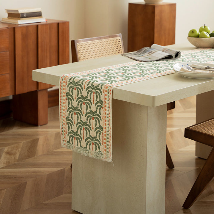 Woven table runner with floral embroidery and fringe trim