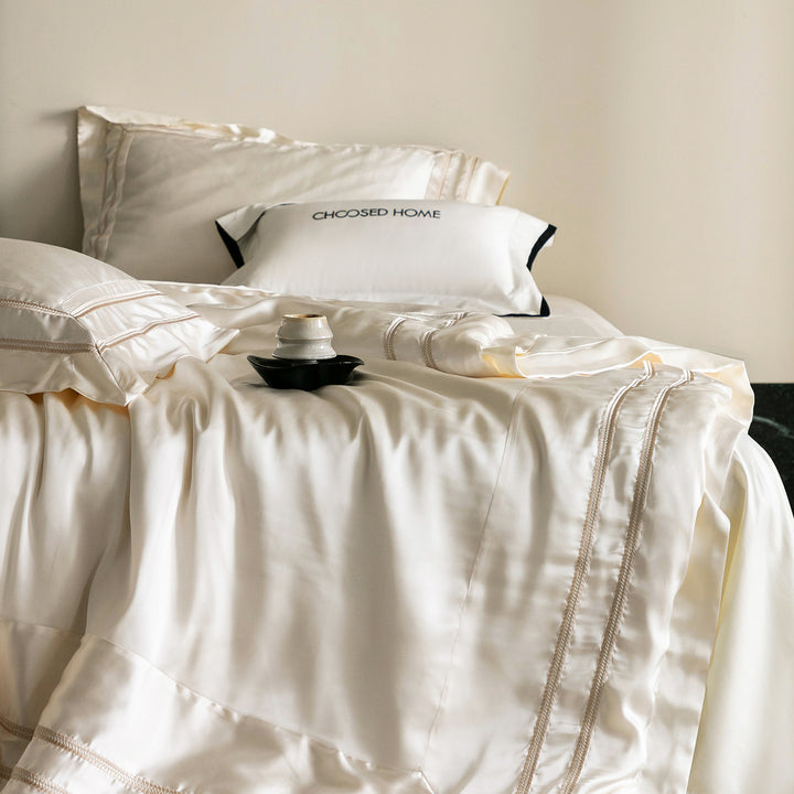 Luxurious satin bedding set with decorative borders and silky-smooth feel
