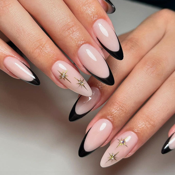Acrylic nail set with elegant black accents and glamorous details Kalsten