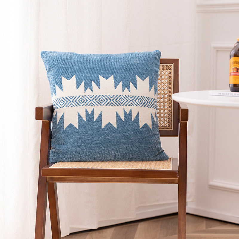 Woven cushion cover with graphic ethnic pattern and contrasting borders