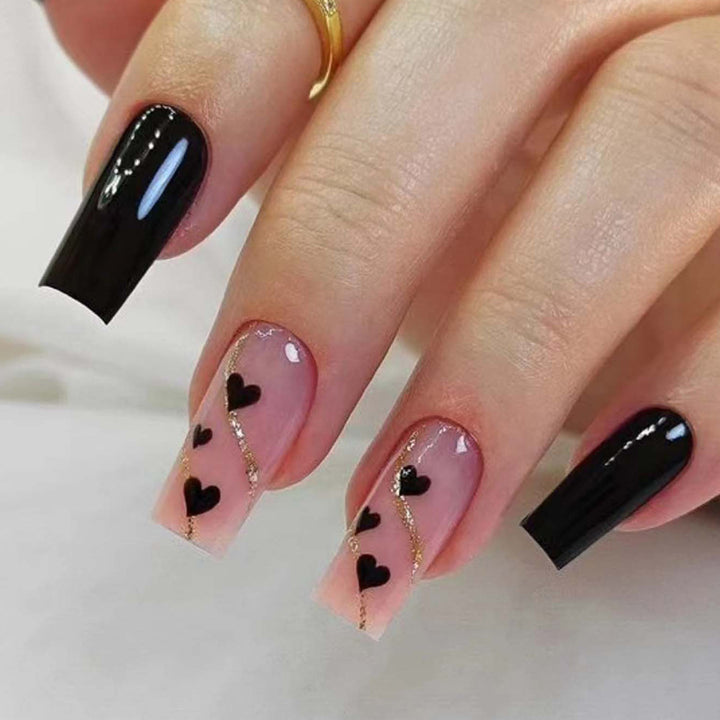 Artistic acrylic nails with heart design and glitter accents Kalsten