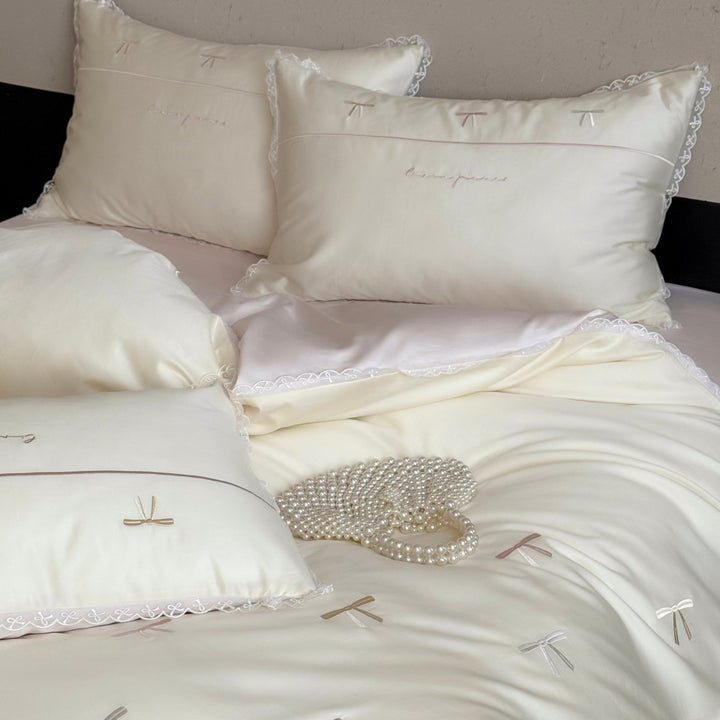 Elegant bedding set made of silky fine satin with embroidered bows and lace trim