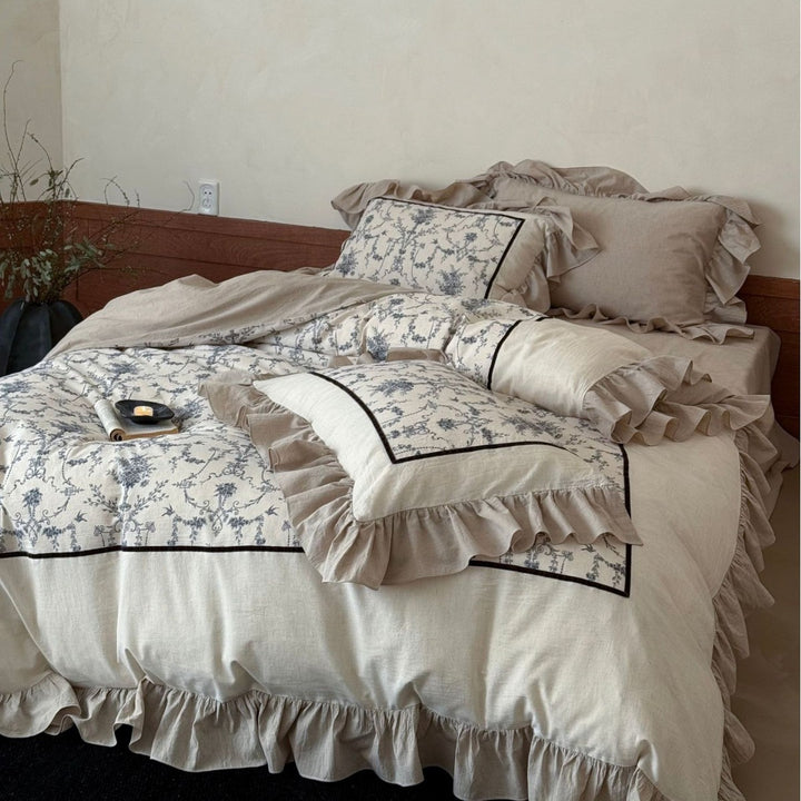 Romantic linen-look bedding set with ruffle, quilted center panel, and fine floral jacquard