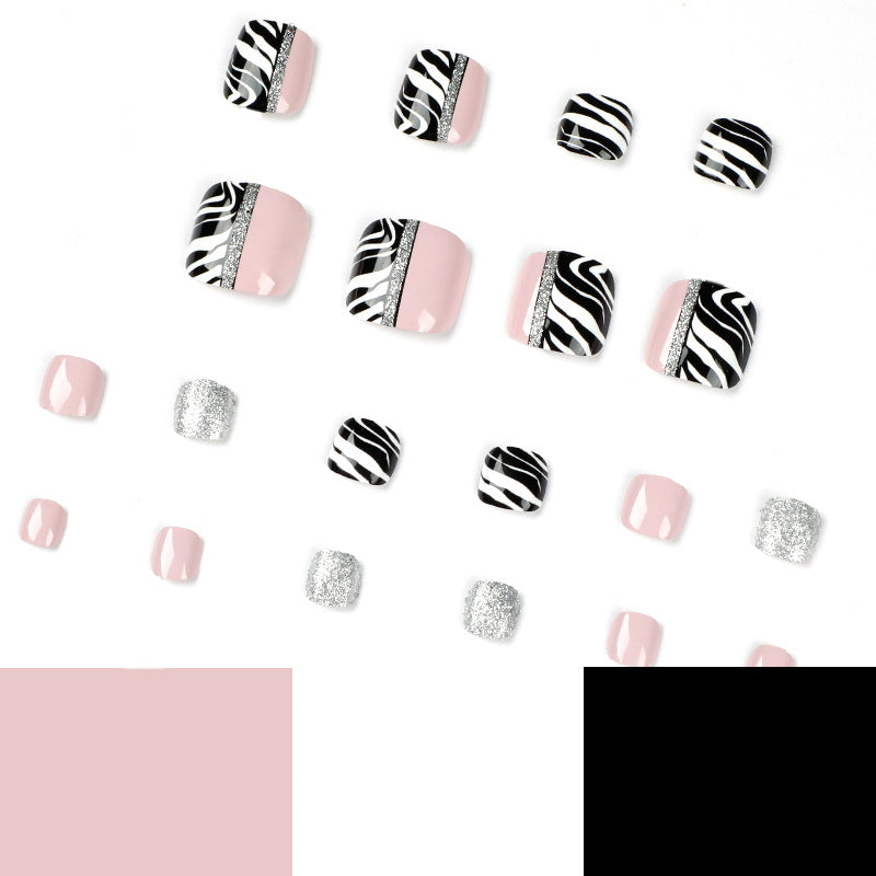 Artistic toenail art with zebra pattern and glitter accents Kalsten