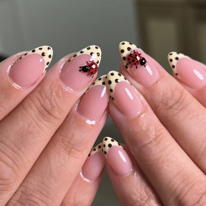 Artful nail art with ladybug motif and polka dots Kalsten