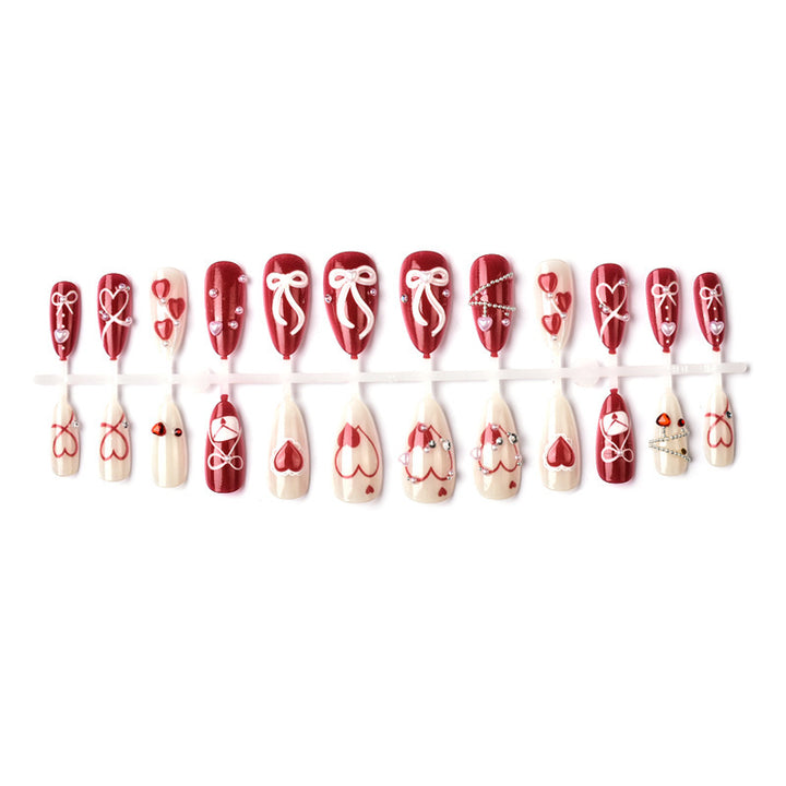 Glamorous artificial nail set with romantic heart design and elegant embellishments Kalsten