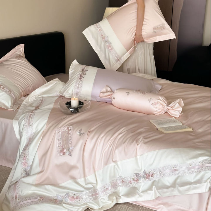 Luxurious cotton satin bed linen set with appliquéd flowers and decorative rolled hem