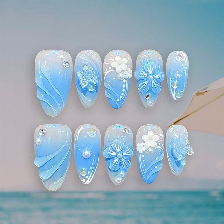 Artificial nail set with glamorous floral designs and creative glitter accents Kalsten