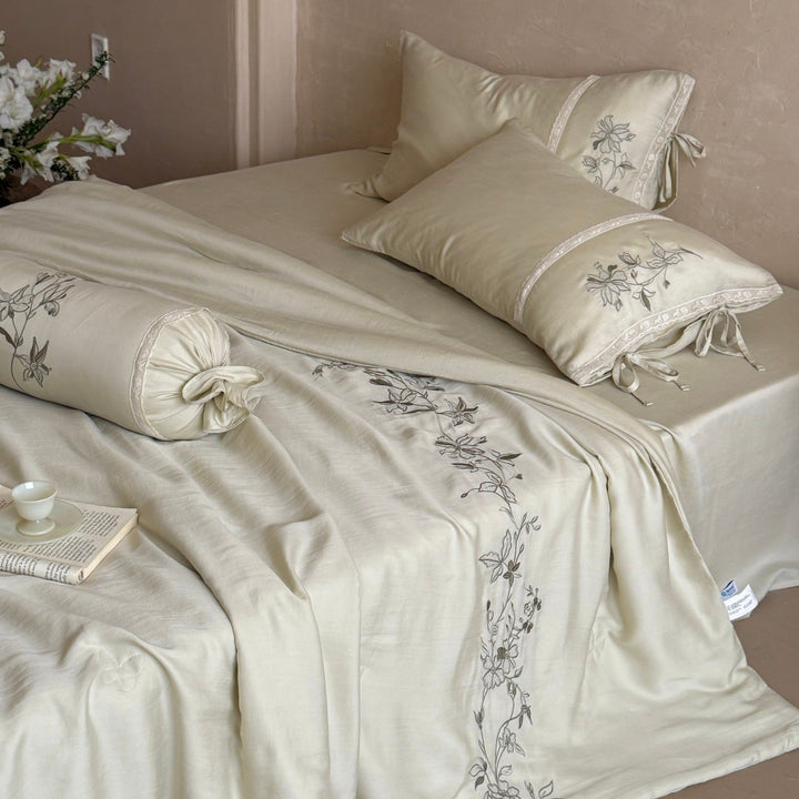 Elegant bedding set made of cotton satin with floral embroidered border and decorative roll cushion Kalsten