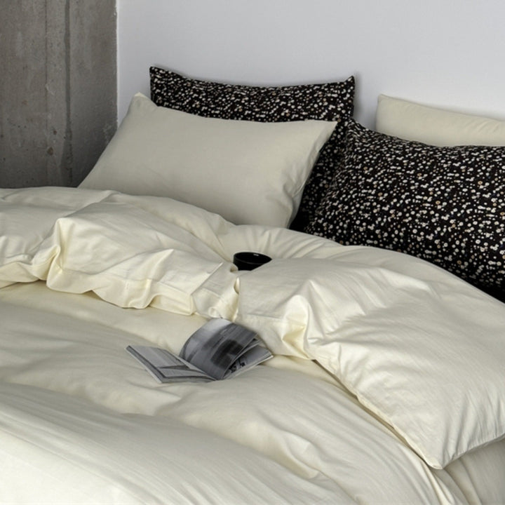 Modern satin bedding set with quilted look and patterned pillowcases