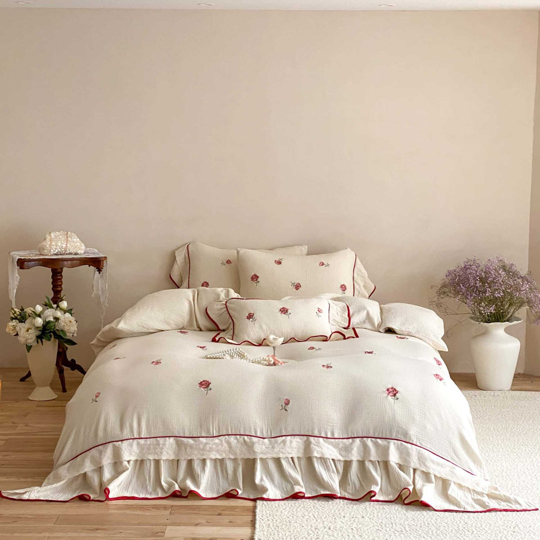 Bedding set made of cotton percale with frill hem, floral embroidery, and decorative ribbons
