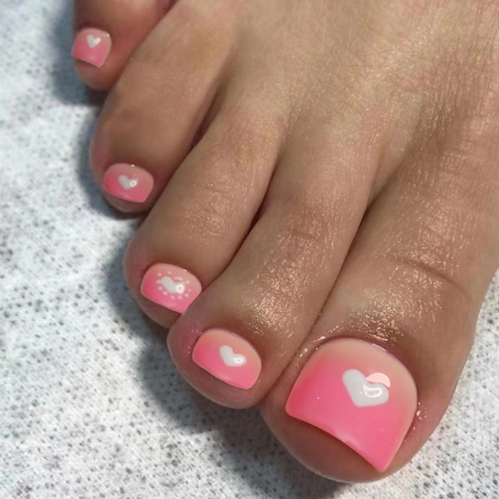 Artful toenail design with heart motifs Kalsten