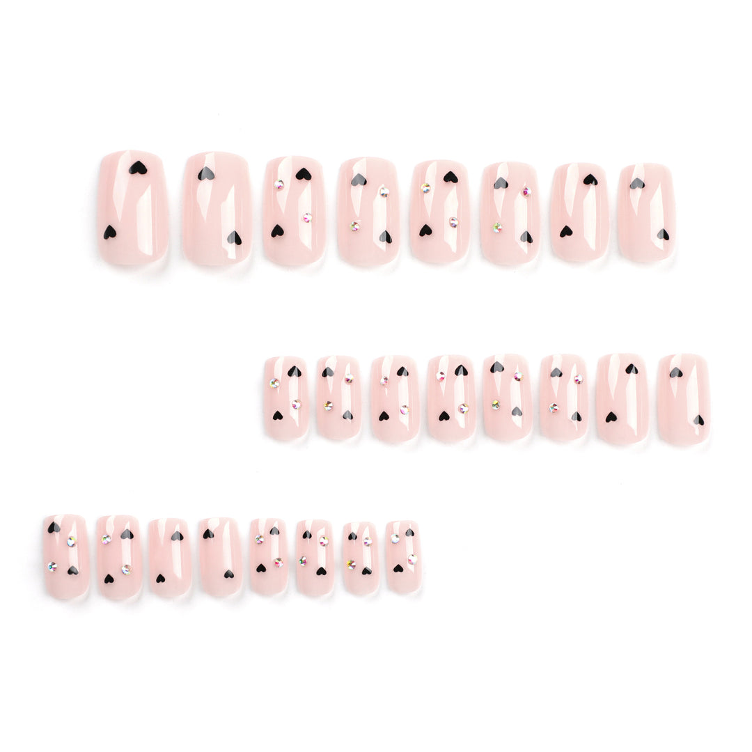 Artistic nail art with heart design and glitter accents Kalsten