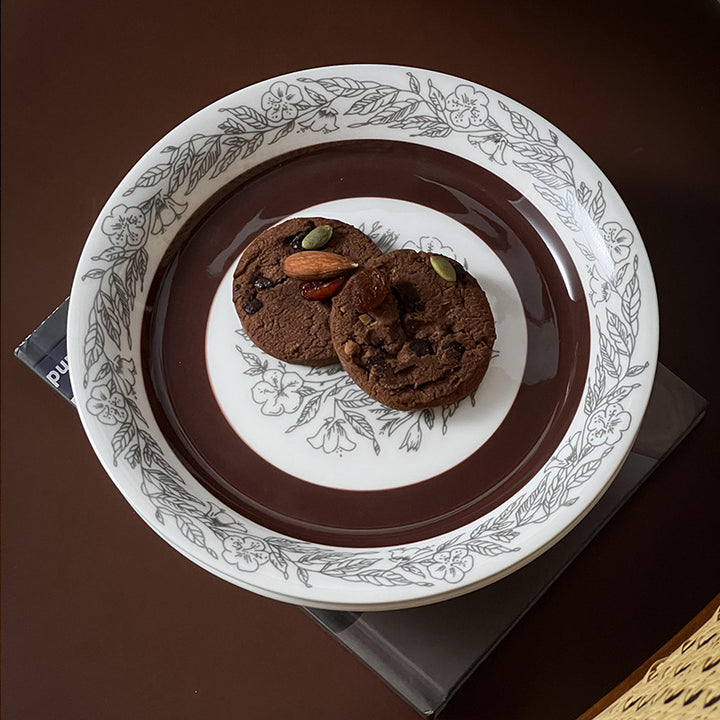 Deep porcelain plate with floral rim ornamentation and contrasting inner mirror