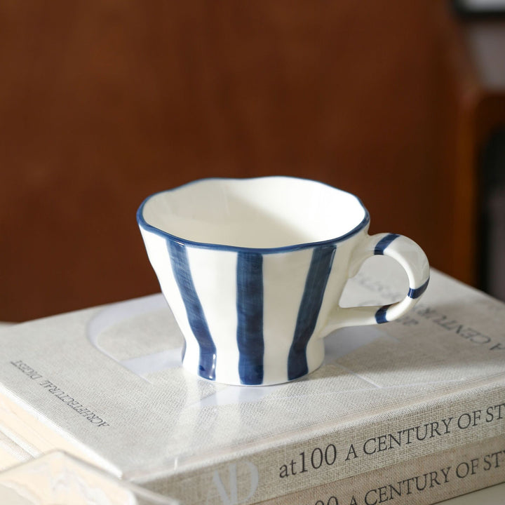 Designer stoneware coffee mug with scalloped rim and vertical brushstroke