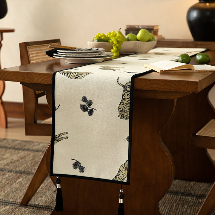 Woven cotton-linen table runner with tiger print and decorative tassels