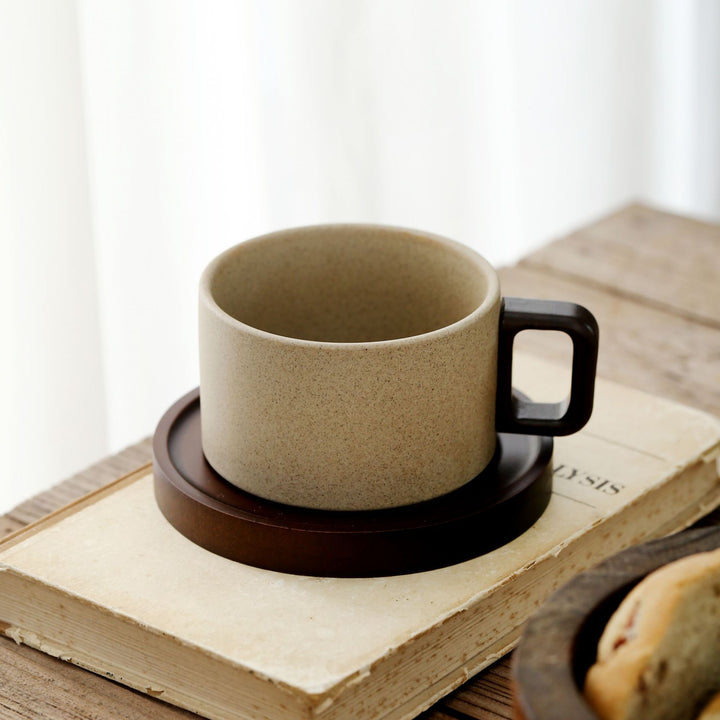 Ceramic mug with ergonomic wooden handle and matching coaster