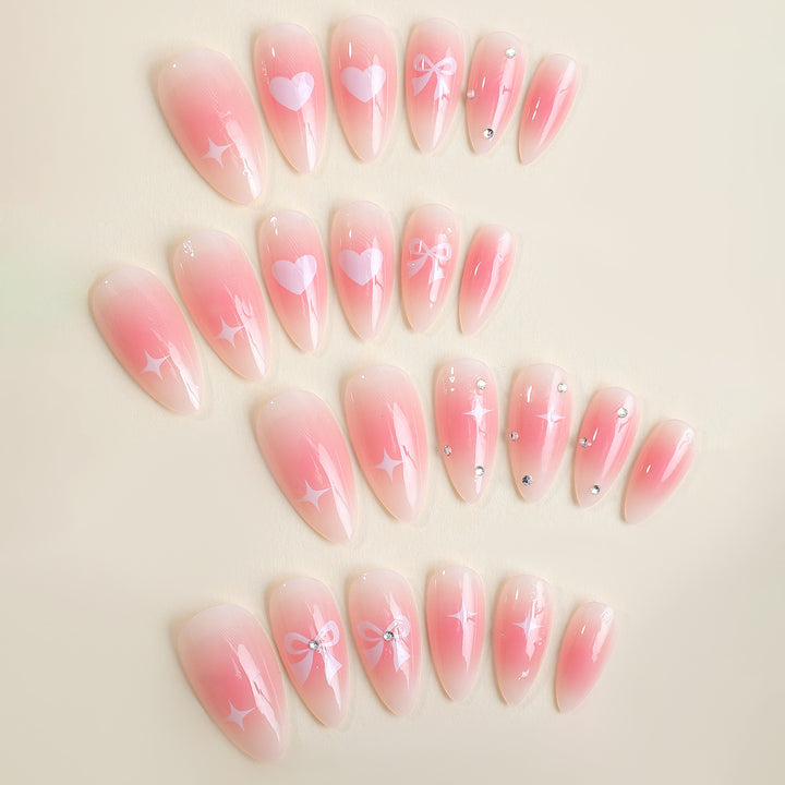 Acrylic nail set with romantic heart and bow design Kalsten