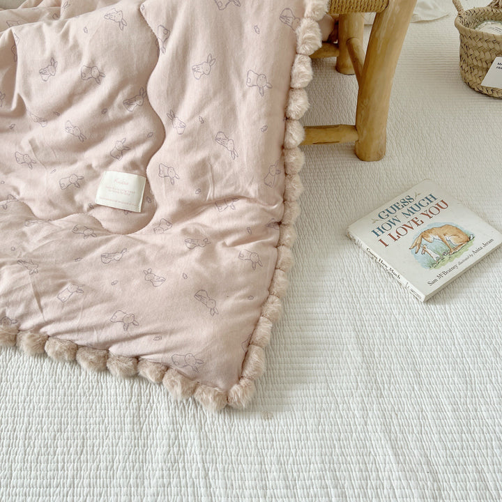 Cuddle blanket baby quilt with plush lining and bunny motif