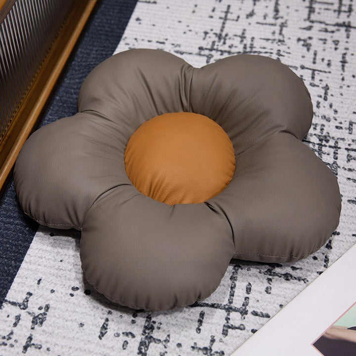 Padded seat cushion in flower shape with faux leather center piece and fluffy edge padding