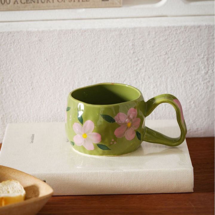 Ceramic mug with hand-painted stripes and flower design