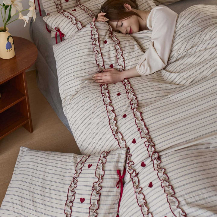 Striped bedding set with ruffles and heart applique