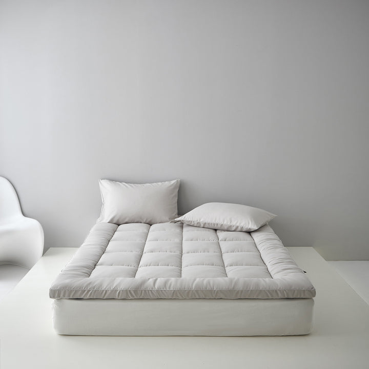 Extra soft quilted mattress topper with border piping and non-slip underside