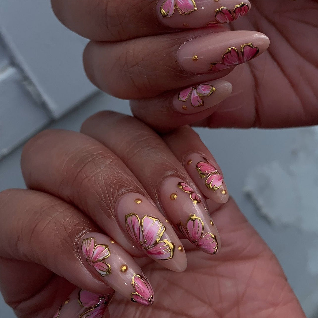 Artful nail art with elegant floral designs and gold accents Kalsten