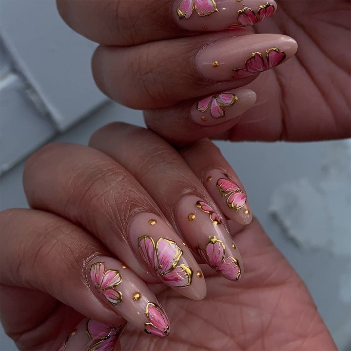 Artful nail art with elegant floral designs and gold accents Kalsten