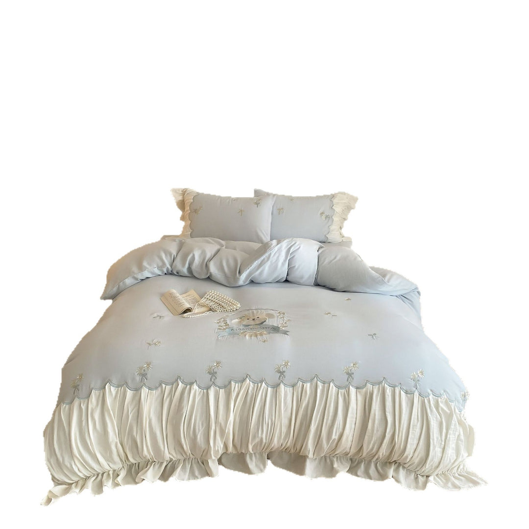 Playful cotton satin bedding set with ruffled bed skirt, floral embroidery, and frill cushion
