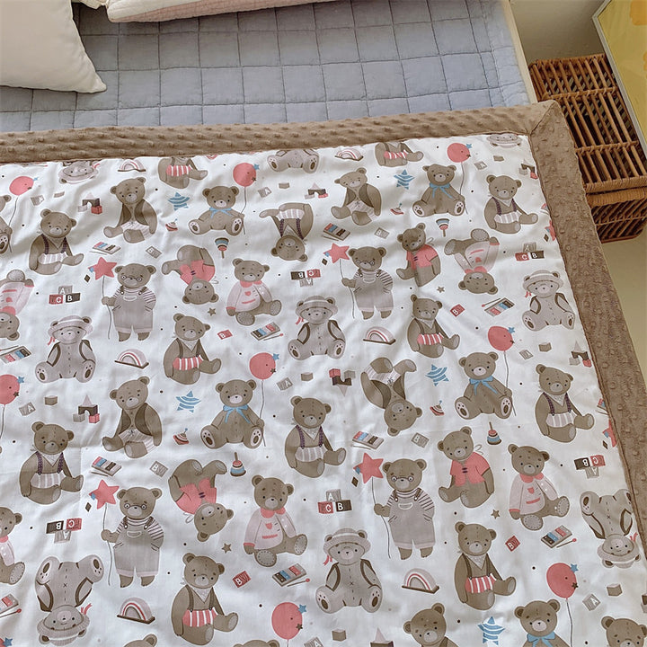 Children's quilt with colorful dinosaur print and soft minky border