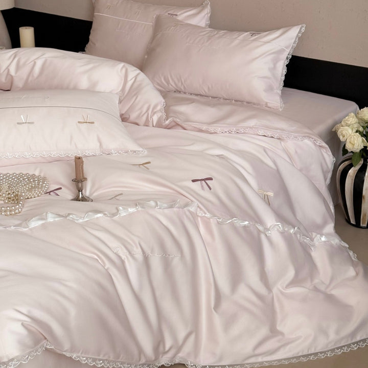 Elegant bedding set made of silky fine satin with embroidered bows and lace trim