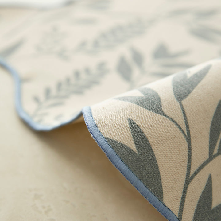 Shaped placemat made of cotton-linen with wavy edge and leaf pattern