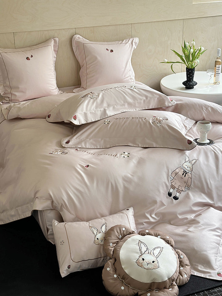 Fine cotton satin bedding set with elaborate bunny embroidery and piped edge