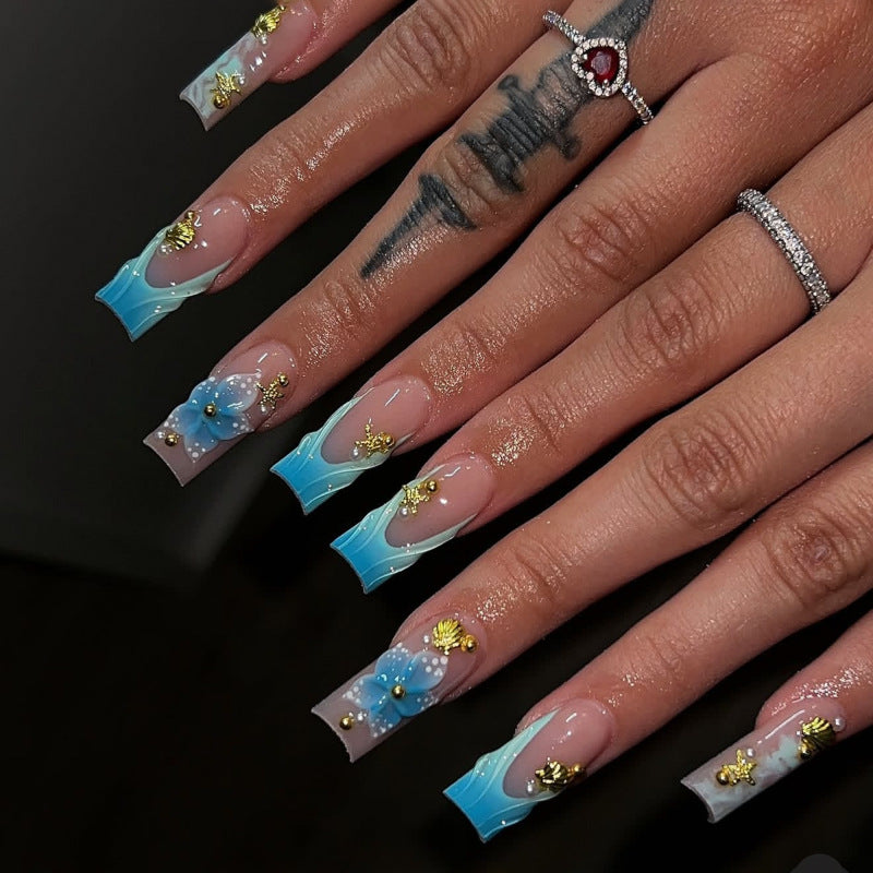 Artful nail art with floral accents and glitter effects Kalsten