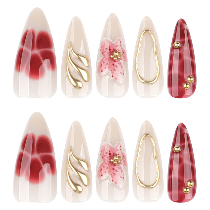 Artful stiletto nails with elegant floral designs and glitter accents Kalsten