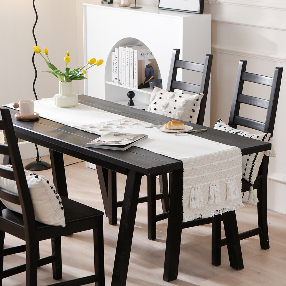 Woven decorative table runner with textured fringes and tactile weaving pattern