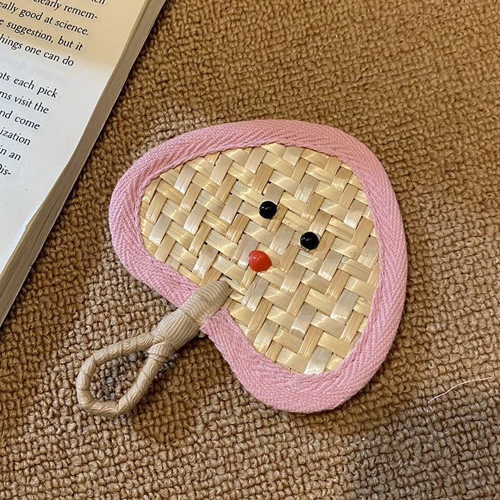 Handcrafted fan with playful face motif Kalsten