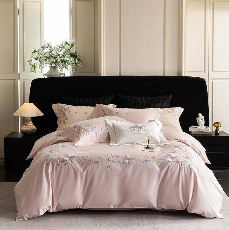 Luxurious embroidered satin bed linen set with floral corner motif and contrast piping